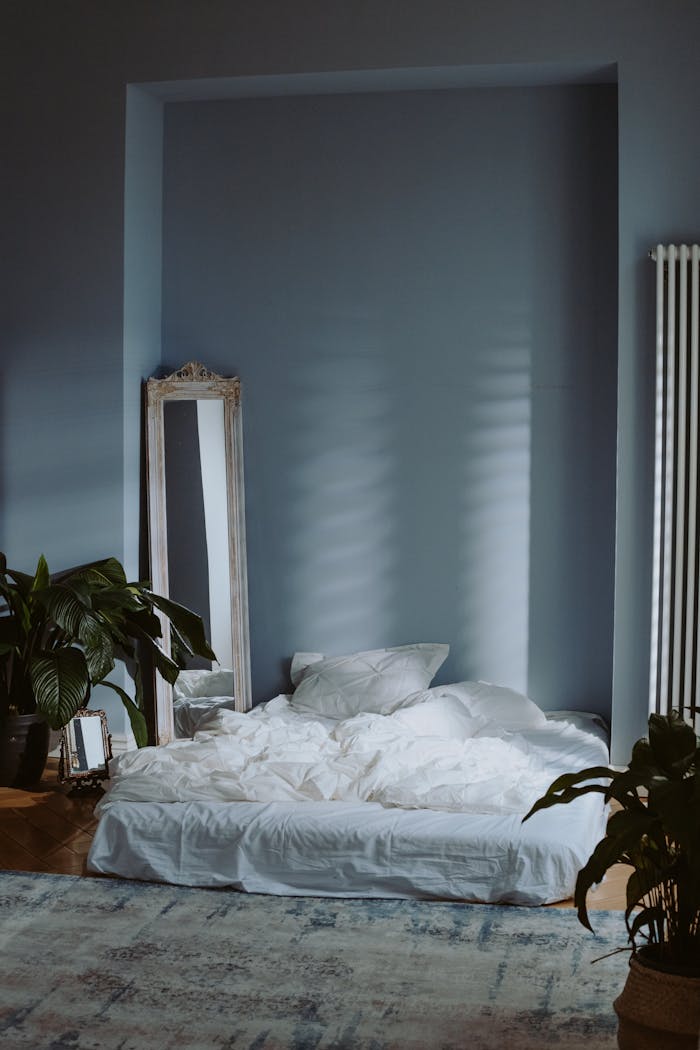 services-02 A serene and minimal bedroom interior with soft lighting and green plants, perfect for a peaceful atmosphere.